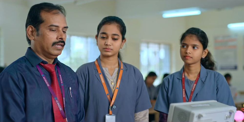 A faculty member working with students on lab equipment