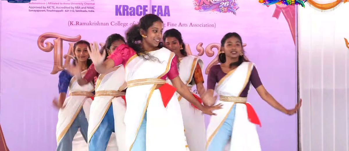 Students in white and gold sarees dancing on the Talentia ’26 stage